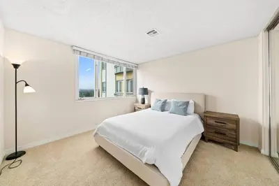 a white bedroom with a bed and a window at Smoky Quartz -Marina View Spacious 3BR near Yacht Club in Los Angeles