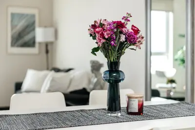 a vase of flowers on a table in a living room at Stylish Vibes 1BD in WEHO in Los Angeles