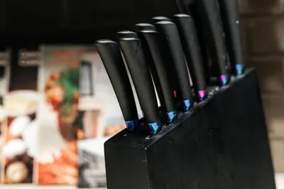 a row of black knives sticking out of a black holder at Stylish Vibes 1BD in WEHO in Los Angeles