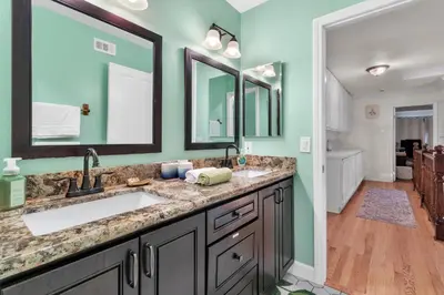a bathroom with two sinks and two mirrors at Oaks Garden in Thousand Oaks