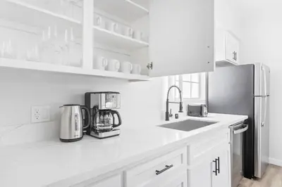 a kitchen with white cabinets and a sink and a refrigerator at Westwood 2BR nr Westwood Village LAX-902 in Los Angeles
