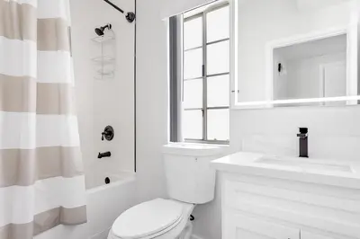 a white bathroom with a toilet and a sink at Westwood 2BR nr Westwood Village LAX-902 in Los Angeles
