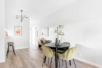 a dining room with a black table and yellow chairs at Westwood 2BR nr Westwood Village LAX-902 in Los Angeles