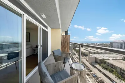 a balcony with chairs and a view of a city at Garnet Glow Full Ocean and Venice Beach view 3BR in Los Angeles