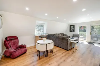 a living room with a couch and a table and chairs at Modern Pine Mountain Club Cabin with Community Pool! in Pine Mountain Club