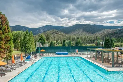 a pool at a resort with mountains in the background at Modern Pine Mountain Club Cabin with Community Pool! in Pine Mountain Club