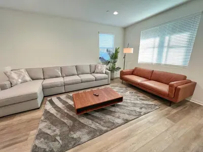 a living room with a couch and a coffee table at Modern Lux Home Near Disneyland And In The Heart Of OC! in Santa Ana