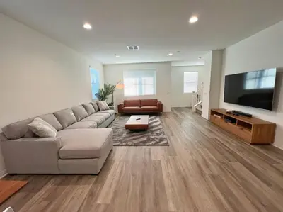 a living room with a couch and a flat screen tv at Modern Lux Home Near Disneyland And In The Heart Of OC! in Santa Ana