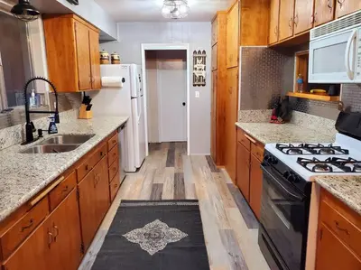 a kitchen with a sink and a stove top oven at The Ponderosa in Running Springs