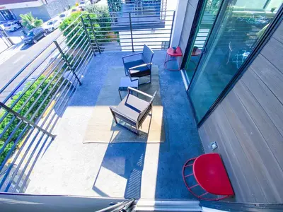 an overhead view of a balcony of a building with benches at Stylish 3 BR/3BR family house in Los Angeles