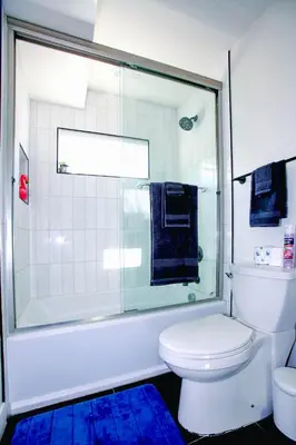 a bathroom with a white toilet and a shower at Stylish 3 BR/3BR family house in Los Angeles