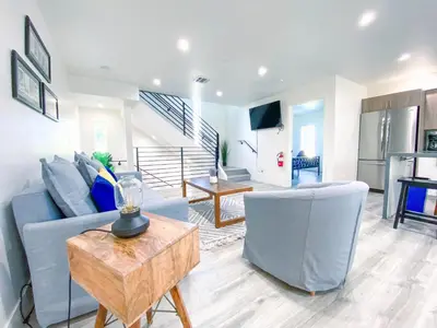 a living room with a blue couch and a table at Stylish 3 BR/3BR family house in Los Angeles