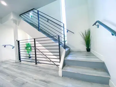 a staircase in a house with a potted plant at Stylish 3 BR/3BR family house in Los Angeles