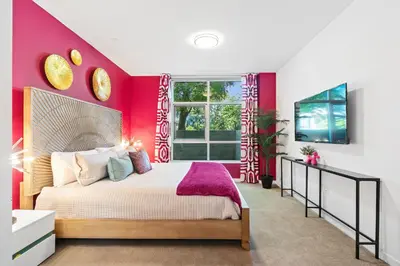 a bedroom with red walls and a large bed at Fairfax District Chic City Oasis 2 BR Apt with Den 136 in Los Angeles