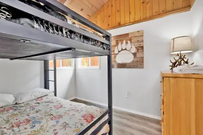 a bedroom with a bunk bed in a room at Storyville Hot Tub- Arcade- Walk To Marina Cabin in Big Bear Lake