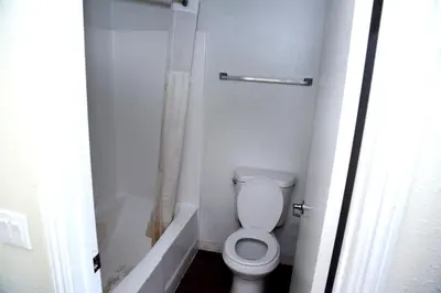 a bathroom with a toilet and a bathtub and a toilet at Airport Stay Motel in Ontario