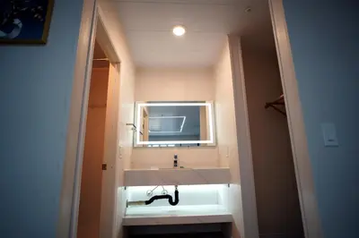a bathroom with a white sink and a mirror at Airport Stay Motel in Ontario