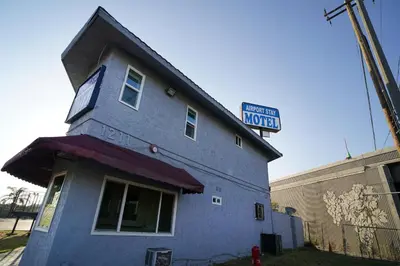 a blue building with a sign on top of it at Airport Stay Motel in Ontario