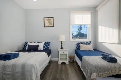 a bedroom with two beds and a window at Comfy 4BR home near Korea Town in Los Angeles