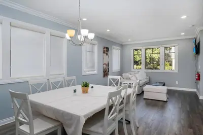 a dining room with a white table and chairs at Comfy 4BR home near Korea Town in Los Angeles