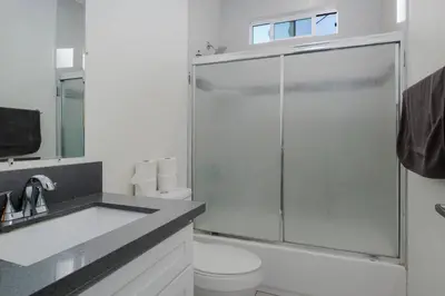 a bathroom with a shower and a toilet and a sink at Comfy 4BR home near Korea Town in Los Angeles