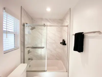 a shower with a glass door in a bathroom at Modern 3BR Home in Mid-City in Los Angeles