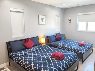 a bedroom with two beds and a couch at Lucky Charm 4 Bedroom Mid-City Apartment in Los Angeles