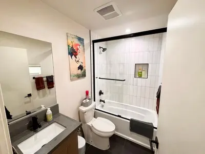 a bathroom with a toilet and a sink and a shower at Cozy Chamber 3 BR Hollywood Townhouse in Los Angeles