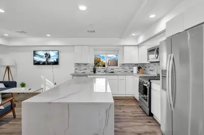 a white kitchen with a large white counter top at Wonderful 3 Bedroom Home Perfect for Getaway in Los Angeles