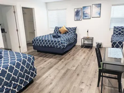 a bedroom with a bed and a couch and a table at Wonderful 3 Bedroom Home Perfect for Getaway in Los Angeles