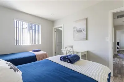 a bedroom with two beds and a window at 5 BR Home Near USC - Perfect Location in Los Angeles