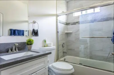 a bathroom with a shower and a toilet and a sink at Cheerful 5BR house with parking near USC in Los Angeles