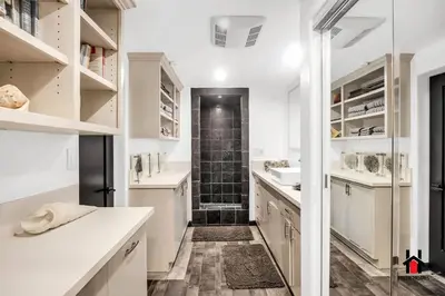 a kitchen with white cabinets and a walk in shower at Resort Feel I Breathtaking Mountain Scenery I Pool in Malibu