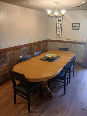 a conference room with a wooden table and chairs at Boulder Bay Cottages in Big Bear Lake