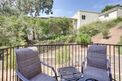 two chairs sitting on a balcony next to a fence at Chic Santa Paula Home with Mountain and City Views! in Santa Paula