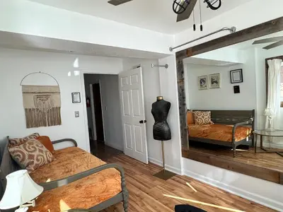 a bedroom with a bed and a mirror on the wall at Chic Santa Paula Home with Mountain and City Views! in Santa Paula