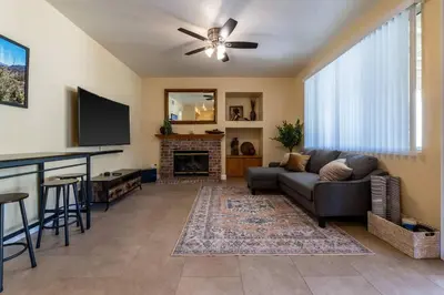 a living room with a couch and a fireplace at The Nest at Woodside: Lux LA getaway + office/spa in Santa Clarita