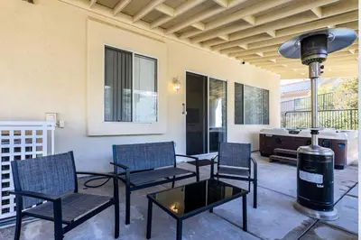 a patio with chairs and a table and a heater at The Nest at Woodside: Lux LA getaway + office/spa in Santa Clarita