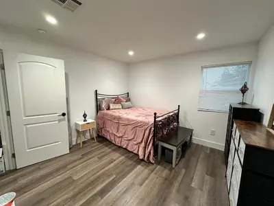a bedroom with a bed and a window and a door at Bright Corner Home Retreat Near SoFi in Los Angeles