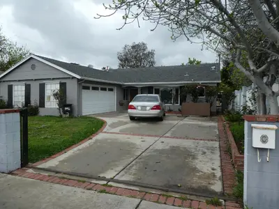 a house with a car parked in the driveway at Nice Northridge 4-2-2 home near CSUN and Pierce College in Northridge
