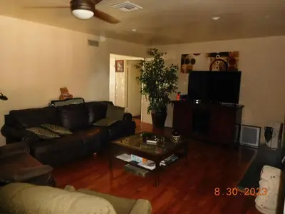 a living room with a couch and a tv at Nice Northridge 4-2-2 home near CSUN and Pierce College in Northridge