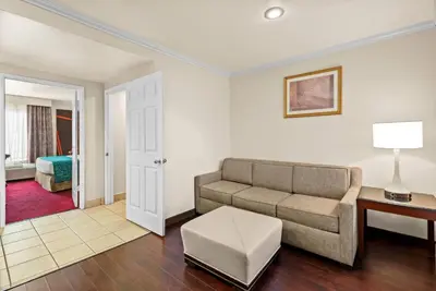 a living room with a couch and a table at Howard Johnson by Wyndham Pasadena in Pasadena