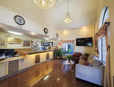 a living room with a couch and a table at Howard Johnson by Wyndham Pasadena in Pasadena
