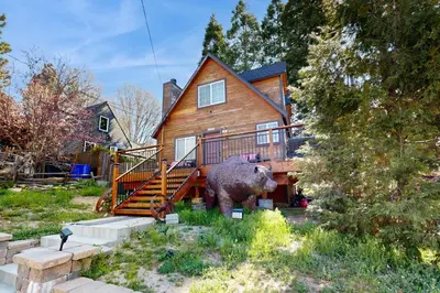 a house with a bear statue in front of it at Heliotrope Hideaway in Lake Arrowhead