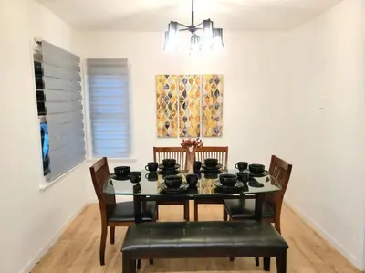 a dining room with a black table and chairs at Newly Furnished Pool House in Los Angeles