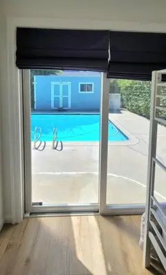 a sliding glass door with a view of a swimming pool at Newly Furnished Pool House in Los Angeles