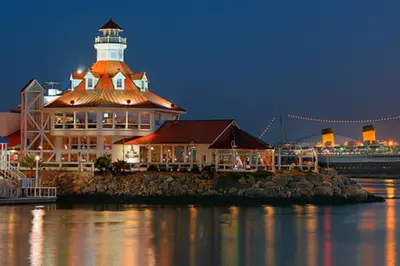 a lighthouse sitting on top of a building next to the water at Huge Updated Spanish Apt - Steps to Beach & Bay! in Long Beach