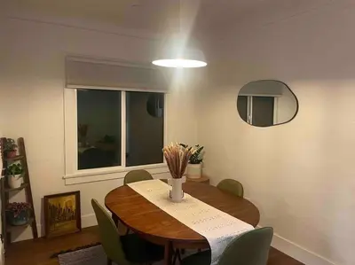 a dining room table with chairs and a round mirror at Huge Updated Spanish Apt - Steps to Beach & Bay! in Long Beach