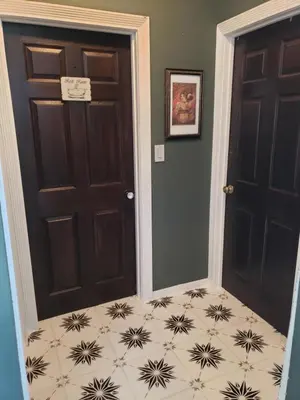 a hallway with two doors and a tile floor at Tranquility at the House of Alchemy Hollywood in Los Angeles
