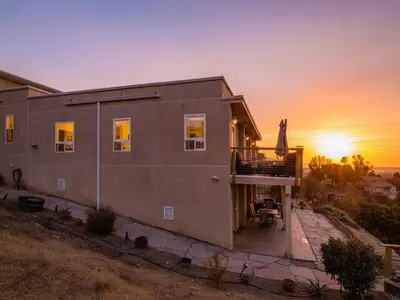 a house with the sunset in the background at The Creek Retreat - Totally private 1Br/1Bd in Newbury Park